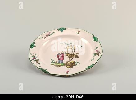 Plate, Veuve Perrin Factory, France, 1748 - 1803, Tin-glazed earthenware painted in muffle colors, Circular cavetto, scalloped rim irregularly ten-sided. Chinoiserie decoration showing a man, Facing left, holding a birds. At right, rocks and a shelter in brown and yellow. Border has three birds and two flying insects alternating with green scalloped panels., Marseille, France, mid- 18th century, ceramics, Decorative Arts, Plate Stock Photo