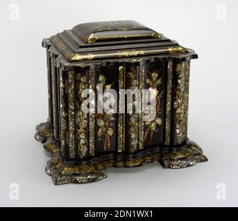 Sewing box with implements, Papier-mâché, wood, mother-of-pearl, velvet, paper, paint, gilt, ivory, Elaborately contoured square box with stepped, slightly domed, hinged lid with scalloped edges; stepped, scalloped base with four broad feet; the black lacquer ground with overall floral and foliate decoration of mother-of-pearl inlay, gilding and touches of paint; lid with scene of large church in landscape, 'Melrose Abbey' in small letters painted under scene; lid opens over compartmented top section; double doors in front open to reveal four drawers, the bottom one designed like a lap desk Stock Photo