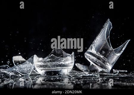 Shards of broken glasses on a black background Stock Photo