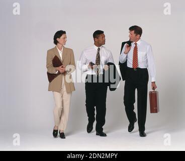 Full length view of three business executives walking. Stock Photo