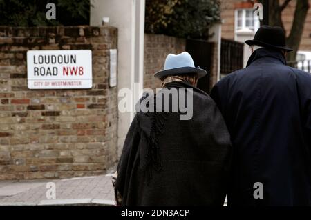 Elderly couple wearing hat strolling in Hampstead. London, England, United Kingdom. Stock Photo