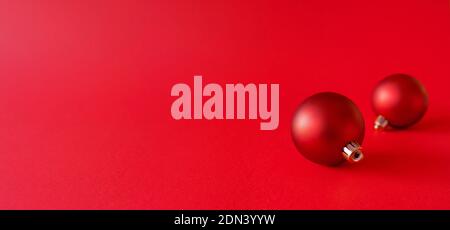 Christmas banner with christmas baubles on red background. Winter holiday ornaments. Red minimal composition. Stock Photo