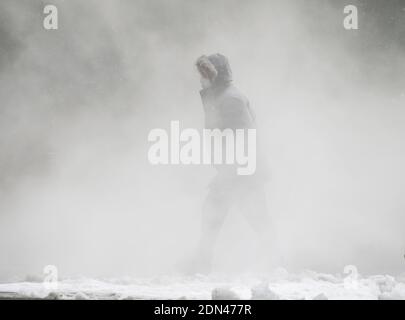 New York, United States. 17th Dec, 2020. A pedestrian walks through snow and steam on the sidewalk in New York City on Thursday, December 17, 2020. A winter storm nor'easter dumped snow in New York and the Northeast with totals in New York City totaling about 12 inches. Photo by John Angelillo/UPI Credit: UPI/Alamy Live News Stock Photo