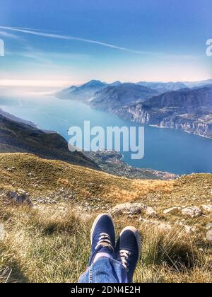 legs in gym shoes on top of a mountain Stock Photo
