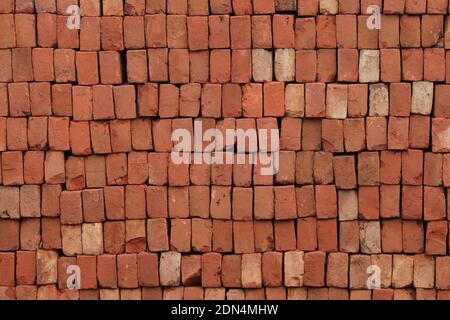 Brick Pattern. Stack of fresh processed bricks loosely stacked horizontally. Stock Photo