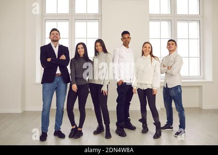 Happy young diverse friends, students or coworkers posing and smiling for group portrait Stock Photo