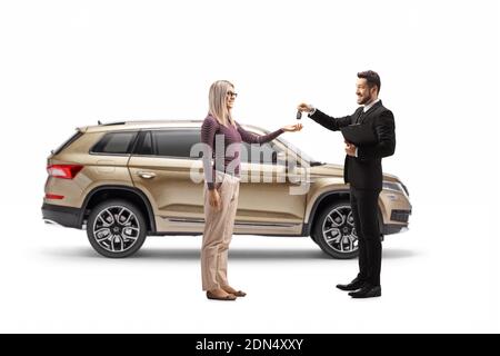 Salesman giving SUV car keys to a blond woman isolated on white background Stock Photo
