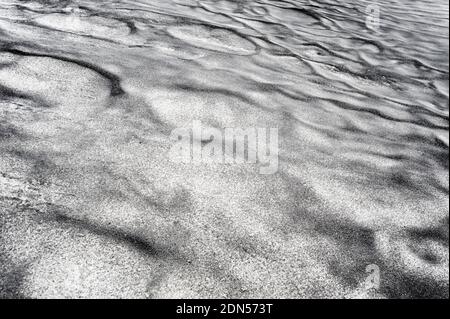 Abstract dirty black sand on snow texture. Stock Photo