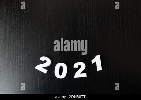 White numbers 2021 on black background close up, new year Stock Photo
