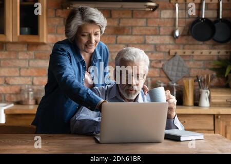Happy middle aged family couple using computer. Stock Photo