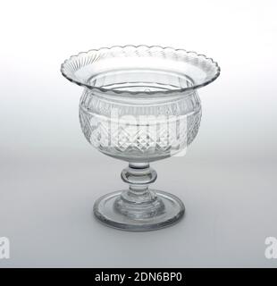 Bowl, Glass, Spherical bowl with wide flaring rim. Stem with flattened knop and stepped circular base. Top rim has scalloped edge and row of cut blazes. Bowl has band of ovals containing shallow cut diamonds, each with 9 smaller diamonds inside; row of facets cutting-above, prismatic rings below., Ireland, ca. 1800–10, glasswares, Decorative Arts, Bowl Stock Photo