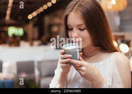 Close up of a lovely woman smelling scented candle Stock Photo