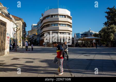 April 22, 2019, Limassol, Cyprus. Children play soccer in the city square . Stock Photo