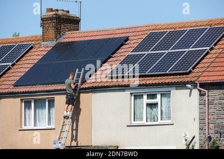 Installation of photovoltaic solar panels on the roof of terraced house in London England United Kingdom UK Stock Photo