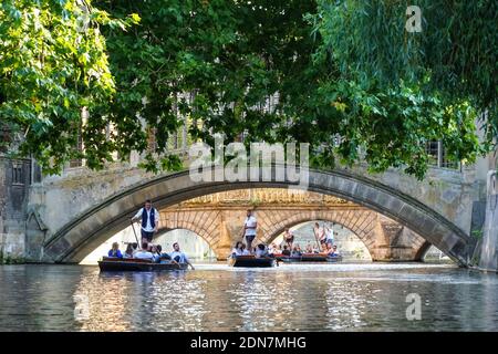 People punting under the Bridge of Sighs on the River Cam in Cambridge, Cambridgeshire England United Kingdom UK Stock Photo