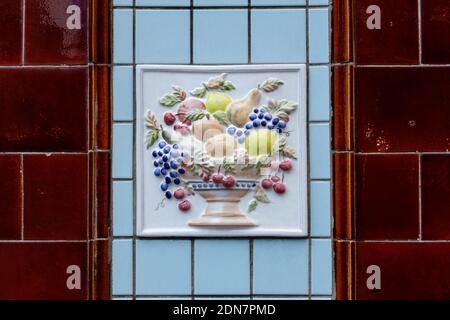 Colourful decorative ceramic tiles in a form of relief on a wall of a building in London England United Kingdom UK Stock Photo