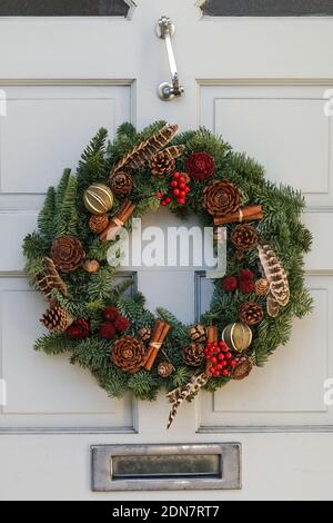 Decorative Christmas wreath on a front door, London England United Kingdom UK Stock Photo