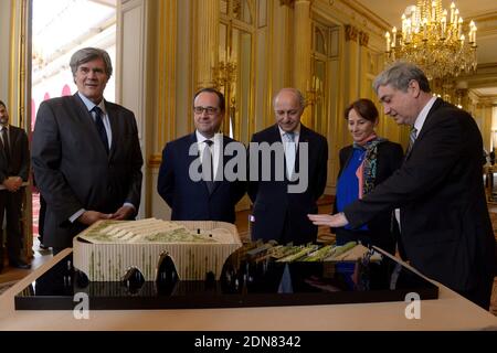 Alain Berger (R), the Commissioner General of the French Pavilion at Expo Milan 2015 presents a model of Pavillon France to (L-R) French Minister of Agriculture Stephane Le Foll, President Francois Hollande, Minister of Foreign Affairs Laurent Fabius and Minister of Ecology Segolene Royal, at the Elysee Palace in Paris, France on March 18, 2015. Photo by Gilles Rolle/Pool/ABACAPRESS.COM Stock Photo