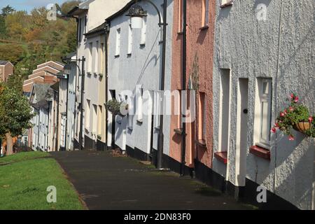A colourful terrace of cottages sloping downhill in Bradninch, Devon Stock Photo