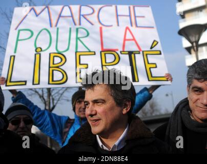 Urgentist and contributor to French satirical magazine Charlie Hebdo Patrick Pelloux poses on January 23, 2015 outside the Hyper Casher shop in Paris, France, prior to a march of freedom organised toward the satirical newspaper Charlie Hebdo offices, two weeks after the attacks in these two Paris places that left 16 dead plus one policewoman in Montrouge, a Paris suburb. France unveiled a raft of measures on January 21, 2015 to curb radicalisation and better monitor jihadists two weeks after an Islamist killing spree in Paris that sent shockwaves across Europe. The banner reads : 'March for fr Stock Photo