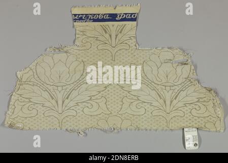 Textile, Medium: silk, metallic foil on a silk core Technique: compound satin, Diagonal repeat of large symmetrical tulip-like flowers with smaller tulip and broad-toothed leaves on either side of stem. Diamond rosette diaper filling interstices. In tarnished white metal threads in plain and fancy twill and coarse white satin ground. Wide plain cloth selvages. Plain satin area on top with fragmentary woven inscription in white on blue band., Russia, 18th century, woven textiles, Textile Stock Photo