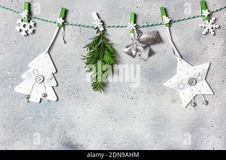 Christmas composition. Christmas ornaments and evergreen tree branches on gray stone background. Christmas, winter, new year concept. Flat lay, top vi