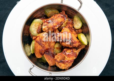 Overhead view of bowl of hot chicken wings and drumsticks for a great spicy flavor. Stock Photo