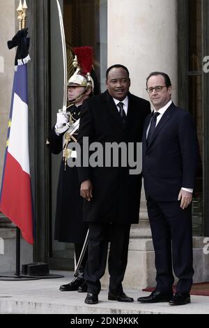 French President Francois Hollande welcomes Niger President Mahamadou Issoufou at the Elysee Palace before attending a Unity rally ÒMarche RepublicaineÓ on January 11, 2015 in Paris in tribute to the 17 victims of a three-day killing spree by homegrown Islamists. The killings began on January 7 with an assault on the Charlie Hebdo satirical magazine in Paris that saw two brothers massacre 12 people including some of the country's best-known cartoonists, the killing of a policewoman and the storming of a Jewish supermarket on the eastern fringes of the capital which killed 4 local residents. Ph Stock Photo