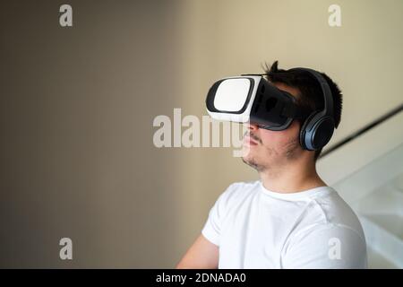 Young guy exited using virtual reality glasses Stock Photo
