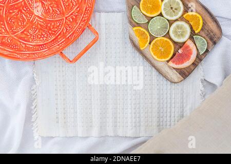Fresh summer picnic flat lay background, with fresh citrus fruit slices and copy space Stock Photo