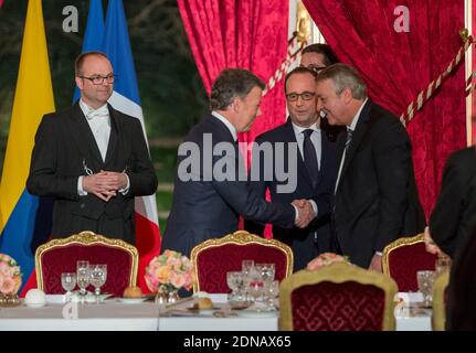 Colombian President Juan Manuel Santos shakes hands with Veolia Environnement CEO Antoine Frerot prior to a state dinner hosted by French President Francois Hollande as part of Santos's two-day state visit to France, at the Elysee Palace in Paris, France on January 26, 2015. Photo Pool by Gilles Rolle/ABACAPRESS.COM Stock Photo