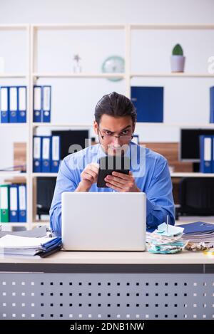 Young bookkeper in budget planning concept Stock Photo