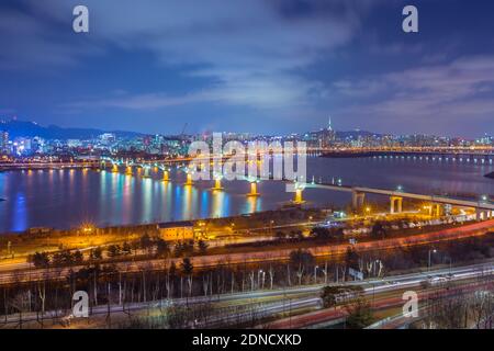Illuminated Bridge Over River Against Sky In City At Night