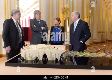 Alain Berger (L), the Commissioner General of the French Pavilion at Expo Milan 2015 presents a model of Pavillon France to (L-R) French Minister of Agriculture Stephane Le Foll, Minister of Ecology Segolene Royal and Minister of Foreign Affairs Laurent Fabius, at the Elysee Palace in Paris, France on March 18, 2015. Photo by Gilles Rolle/Pool/ABACAPRESS.COM Stock Photo