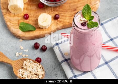 Homemade yogurt smoothie with banana, cranberry and oatmeal Stock Photo