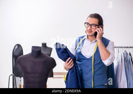 Young tailor working at workshop Stock Photo