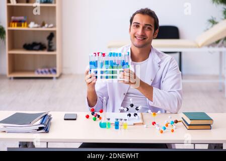 Young male chemist student working in the lab Stock Photo