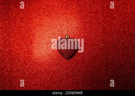 red shiny heart on a red background. background for valentine's day Stock Photo