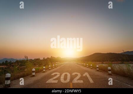 New year 2021 concept. word 2021 written on the asphalt road at sunset or sunrise background. Stock Photo