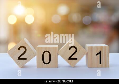 Geometric wood cubes on table with numbers 2021, Concept of new year 2021, copy space. Stock Photo