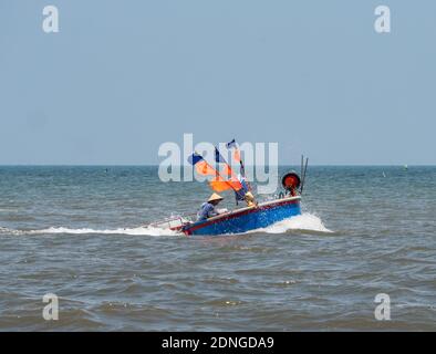 Round fishing boat, typical for the region, off the coast of Bai Sau Beach in Vung Tau in the Bang Ria-Vung Tau Province of South Vietnam. Stock Photo