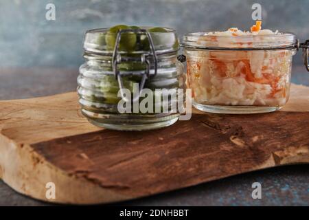 Fermented vegetarian canned food concept. Sauerkraut and olives in glass jars. The concept of canned food Stock Photo