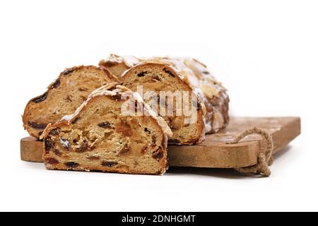 German Stollen cake, a fruit bread with nuts, spices, and dried or candied fruits with powdered sugar traditionally served during Christmas time Stock Photo