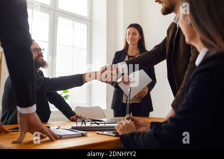 Business people making a deal and shaking hands after a negotiation meeting in the office Stock Photo