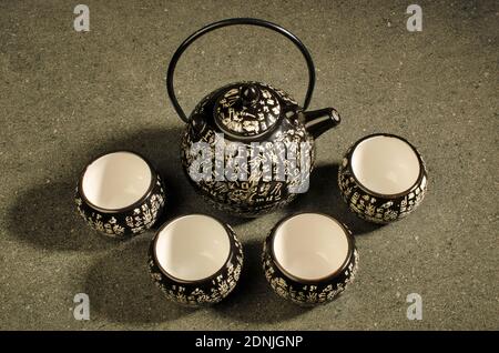 Traditional Kettle and tea Set with Chinese Script . Top angle. Studio Shot Stock Photo