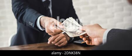 Banner of businessman giving money, Japanese yen currency, to his partner in office  - loan, payment and bribery concept Stock Photo