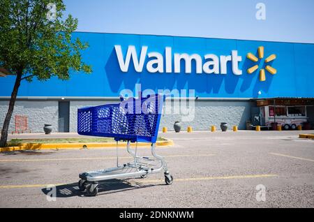 Mendoza, Argentina - January, 2020: Shopping cart on a parking lot in front of main entrance to Walmart supermarket outdoor on the street with no peop Stock Photo
