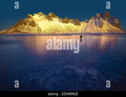 mountaineer at sunrise in stokksnes Stock Photo