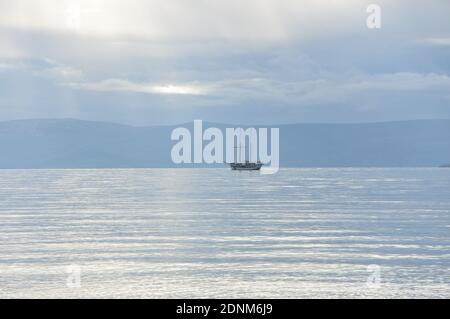 Sailing boat in Adriatic Sea. Sailboat on the beach. Adriatic Sea. Ship silhouette on the sea.
