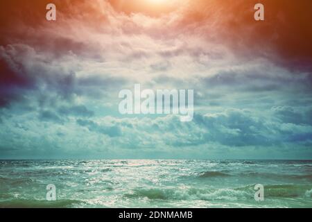 Seascape. Dramatic sunset over the sea. Landscape with ocean and bright evening cloudy sky Stock Photo